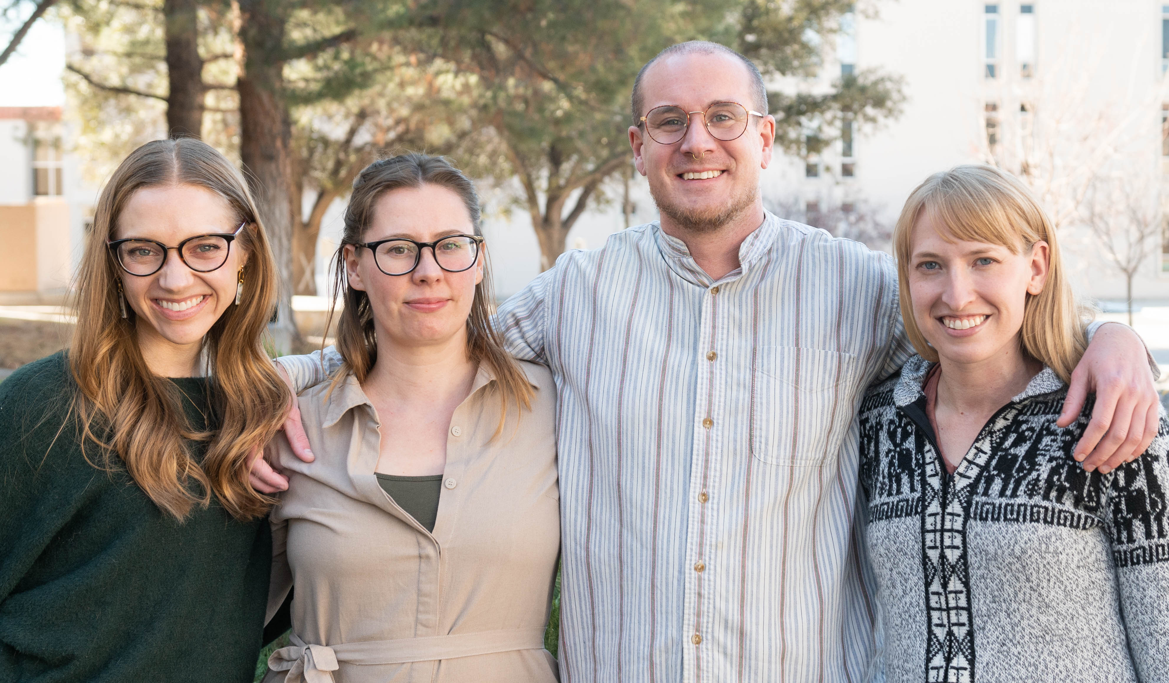 four students smiling